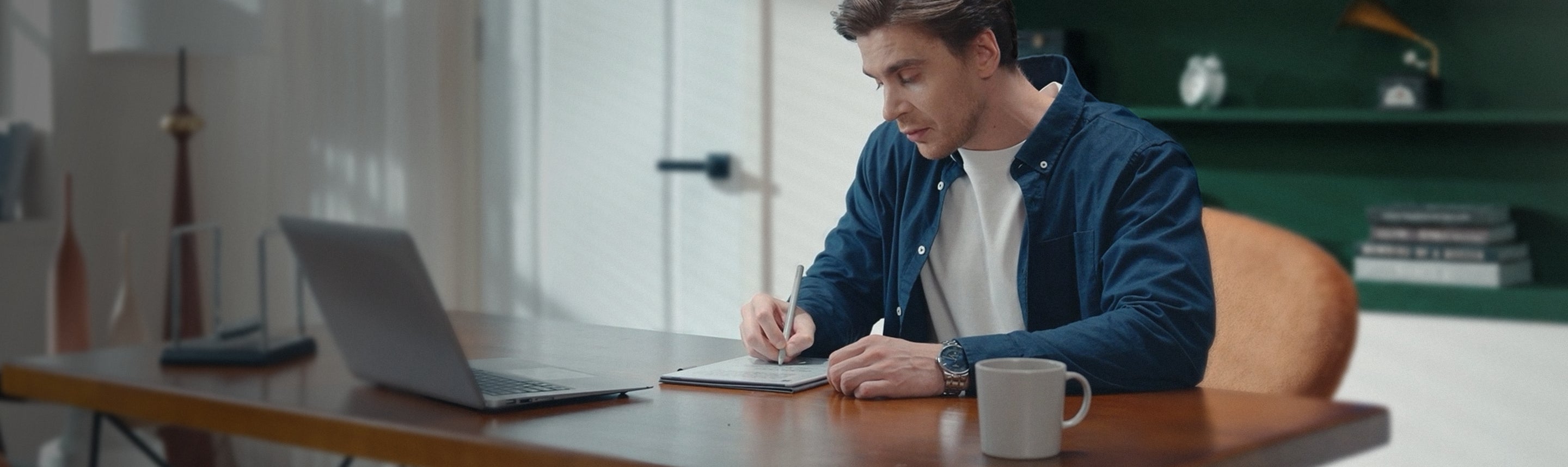 Person working at a desk and writing on Viwoods AiPaper for digital notes, planning, and productivity.